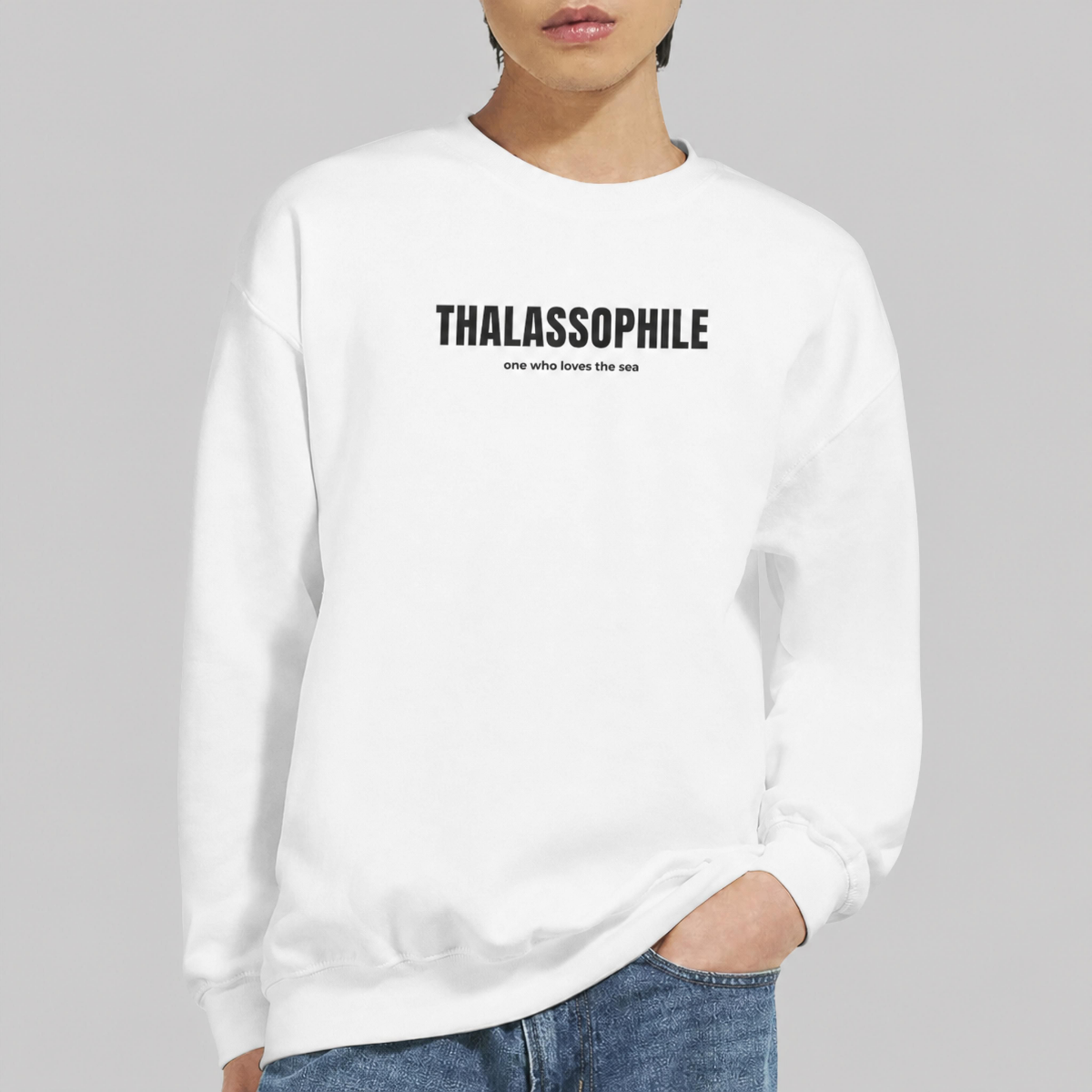 Model wearing a white Thalassophile sweatshirt with the definition one who loves the sea